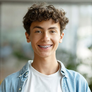 a young man smiling with braces