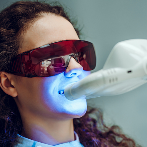 Close-up of woman receiving professional teeth whitening