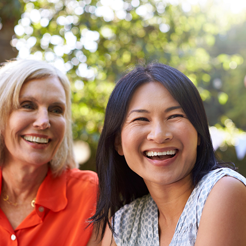 Two women sitting outside and laughing