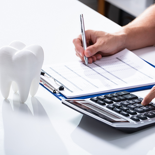 Form on clipboard, calculator, and tooth paperweight