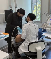 Dental team members treating a patient