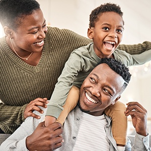 Parents smiling with child at home