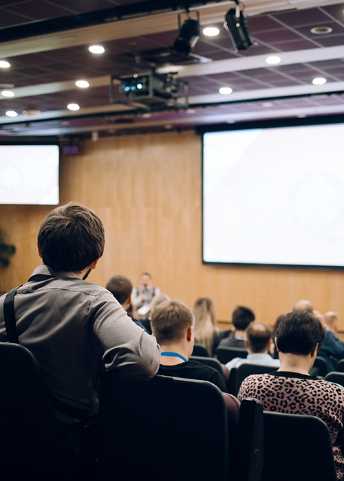 Several students sitting in a lecture hall