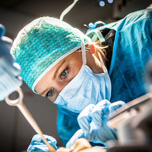 Close-up of dentist with mask treating patient