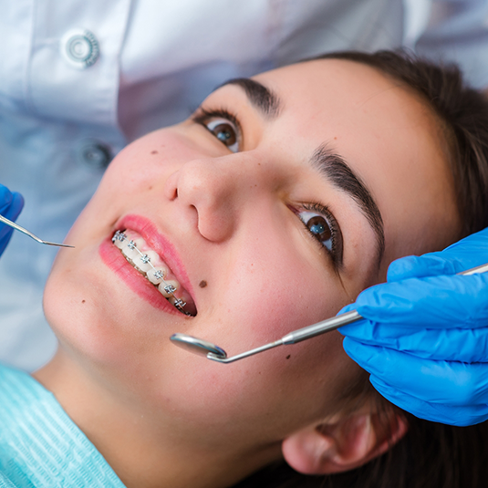 Woman with braces about to undergo checkup